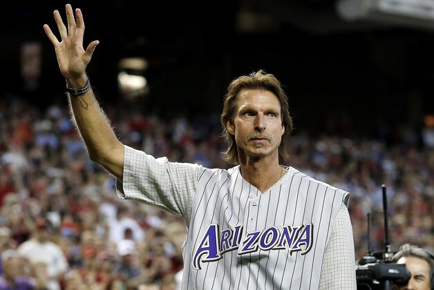 Former Arizona Diamondbacks pitcher Randy Johnson waves to the crowd during ceremonies commemorating the 10th anniversary of Johnson's perfect game prior to a baseball game between the Diamondbacks and the Los Angeles Dodgers on Sunday, May 18, 2014, in Phoenix. (AP Photo/Ross D. Franklin)