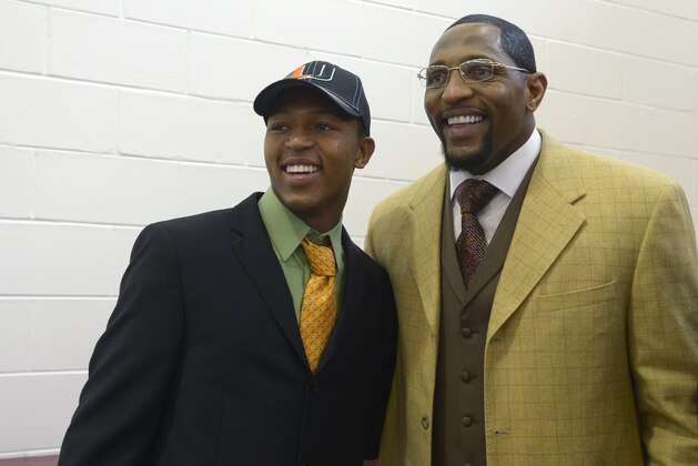 Ray Lewis III, left, and his father, former Baltimore Ravens linebacker Ray Lewis Jr., share a laugh after his national signing day ceremony in the Lake Mary Prep auditorium in Lake Mary, Fla., Wednesday, Feb. 6, 2013. Lewis signed a letter of intent to play football at the University of Miami, where his father also played college football. (AP Photo/Phelan M. Ebenhack)