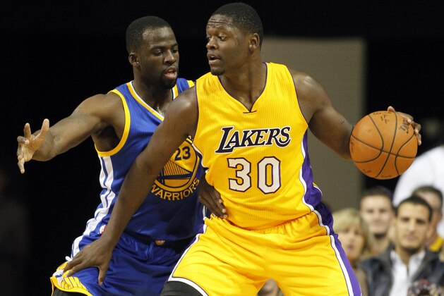 Los Angeles Lakers forward Julius Randle (30) backs in against Golden State Warriors forward Draymond Green, left, during the second half of a preseason NBA basketball game, Sunday, Oct. 12, 2014, in Ontario, Calif. The Warriors won 116-75. (AP Photo/Alex Gallardo)