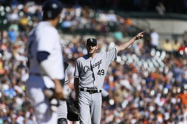 Chicago White Sox starting pitcher Chris Sale (49) points to the outfield while talking to Detroit Tigers' Victor Martinez, who was hit by the previous pitch, in the sixth inning of a baseball game in Detroit Wednesday, Sept. 24, 2014. (AP Photo/Paul Sancya)