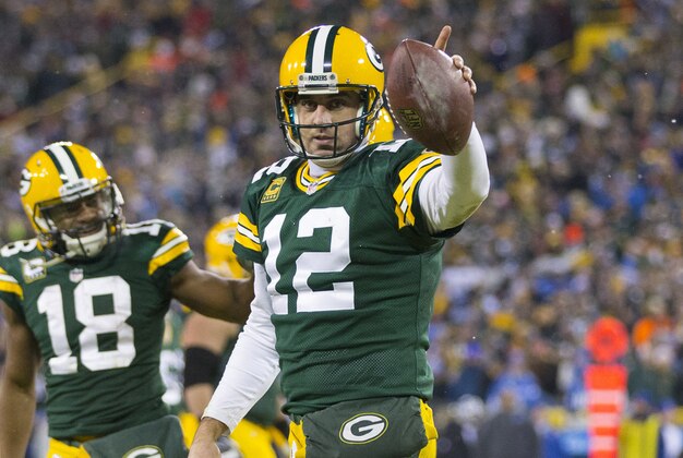 Dec 28, 2014; Green Bay, WI, USA; Green Bay Packers quarterback Aaron Rodgers (12) celebrates after scoring a touchdown during the fourth quarter against the Detroit Lions at Lambeau Field.  Green Bay won 30-20.  Mandatory Credit: Jeff Hanisch-USA TODAY Sports