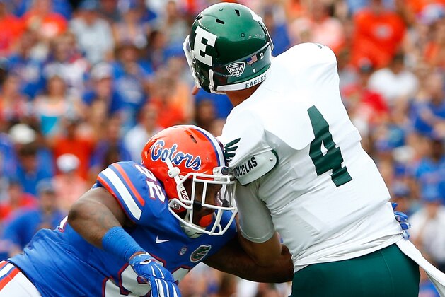 GAINESVILLE, FL - SEPTEMBER 06: Gerald Willis #92 of the Florida Gators pressures Brogan Roback #4 of the Eastern Michigan Eagles  during the game at Ben Hill Stadium on September 6, 2014 in Gainesville, Florida.  (Photo by Sam Greenwood/Getty Images)