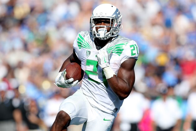 PASADENA, CA - OCTOBER 11:  Running back Royce Freeman #21 of the Oregon Ducks carries the ball on a two yard run for a touchdown in the fourth quarter against he UCLA Bruins at the Rose Bowl on October 11, 2014 in Pasadena, California.  Oregon won 42-30.  (Photo by Stephen Dunn/Getty Images)