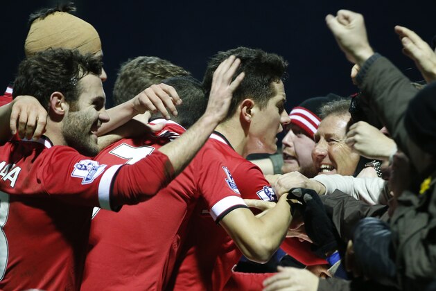 Manchester United’s Ander Herrera, center, celebrates after scoring the opening goal during their English FA Cup third round soccer match between Yeovil Town and Manchester United at Huish Park stadium in Yeovil, England, Sunday, Jan.  4, 2015 . (AP Photo/Alastair Grant)