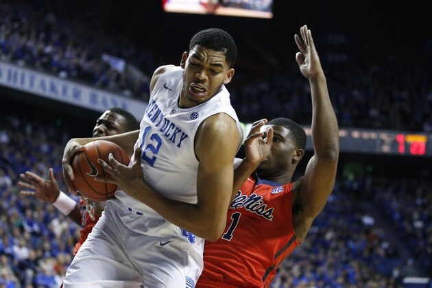 LEXINGTON, KY - JANUARY 6: Karl-Anthony Towns #12 of the Kentucky Wildcats rebounds against Martavious Newby #1 of the Mississippi Rebels in the first half of the game at Rupp Arena on January 6, 2015 in Lexington, Kentucky. (Photo by Joe Robbins/Getty Images)