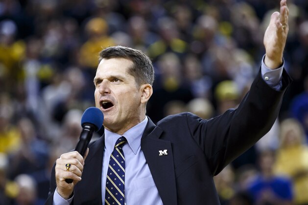 Dec 30, 2014; Ann Arbor, MI, USA; Michigan Wolverines head football coach Jim Harbaugh address the crowd during halftime of the game against the Illinois Fighting Illini at Crisler Center. Mandatory Credit: Rick Osentoski-USA TODAY Sports