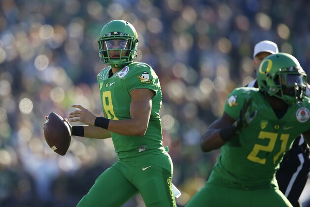 Oregon quarterback Marcus Mariota (8) looks to pass against Florida State in the Rose Bowl NCAA college football playoff semifinal, Thursday, Jan. 1, 2015 in Pasadena, Calif. Oregon defeated Florida State 59-20 to advance to the first ever NCAA football playoff championship game. (AP Photo/Doug Benc)