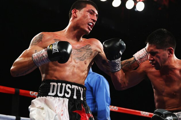 NEW YORK, NY - NOVEMBER 02:  Dusty Hernandez-Harrison punches Josh Torres during their Welterweight fight at The Theater at Madison Square Garden on November 2, 2013 in New York City.  (Photo by Al Bello/Getty Images)