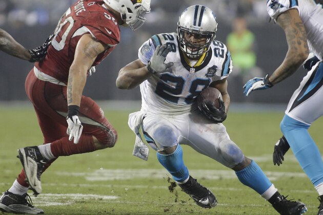 Carolina Panthers' Jonathan Stewart (28) runs as Arizona Cardinals' Larry Foote (50) defends in the second half of an NFL wild card playoff football game in Charlotte, N.C., Saturday, Jan. 3, 2015. (AP Photo/Bob Leverone)