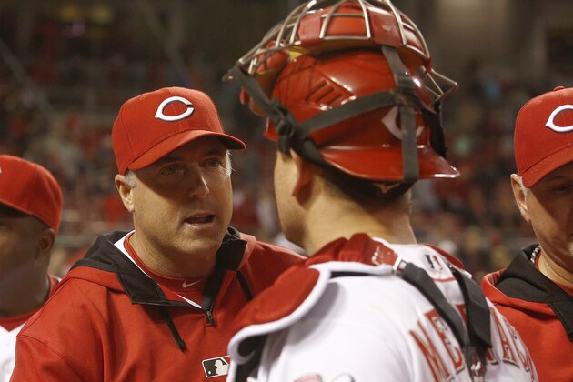 Cincinnati Reds manager Bryan Price, left, congratulates catcher Devin Mesiraco after the Reds defeated the Milwaukee Brewers 3-1 in a baseball game, Tuesday, Sept. 23, 2014, in Cincinnati. (AP Photo/David Kohl)
