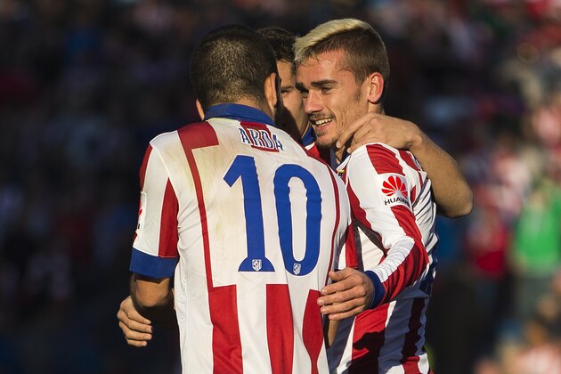 Antoine Griezmann, right, celebrates his goal with teammates during a Spanish La Liga soccer match between Atletico de Madrid and Levante at the Vicente Calderon stadium in Madrid, Spain, Saturday, Jan. 3, 2015. (AP Photo/Andres Kudacki)