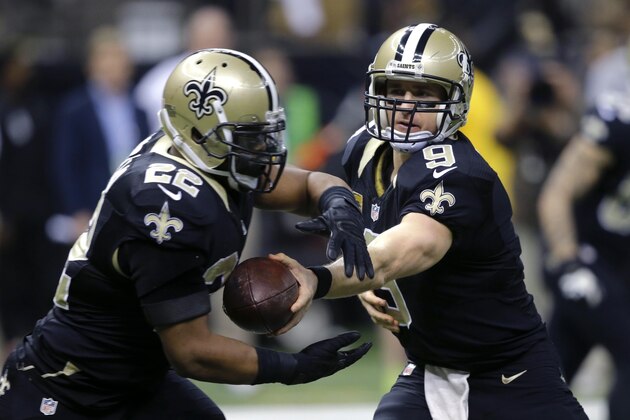 New Orleans Saints quarterback Drew Brees (9) hands off to running back Mark Ingram (22) in the first half of an NFL football game against the Atlanta Falcons in New Orleans, Sunday, Dec. 21, 2014. (AP Photo/Bill Haber)