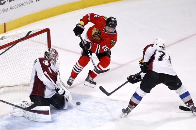 Colorado Avalanche goalie Semyon Varlamov (1) makes a save on a shot by Chicago Blackhawks center Marcus Kruger (16) as Marc-Andre Cliche (24) also defends during the third period of an NHL hockey game Tuesday, Jan. 6, 2015, in Chicago. The Avalanche won 2-0. (AP Photo/Charles Rex Arbogast)