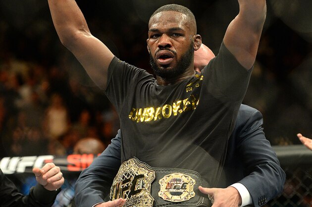 Jan 3, 2015; Las Vegas, NV, USA; Jon Jones (red gloves) celebrates after defeating Daniel Cormier (not pictured) in their light heavyweight title fight at UFC 182 at the MGM Grand Garden Arena. Jones won. Mandatory Credit: Jayne Kamin-Oncea-USA TODAY Sports