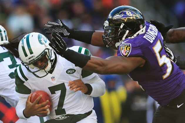 BALTIMORE, MD - NOVEMBER 24: Quarterback Geno Smith #7 of the New York Jets is hit by outside linebacker Elvis Dumervil #58 of the Baltimore Ravens during the first half at M&T Bank Stadium on November 24, 2013 in Baltimore, Maryland.  (Photo by Rob Carr/Getty Images)