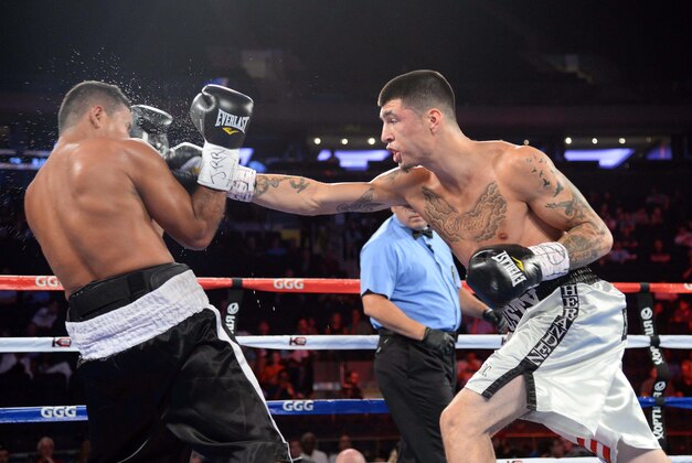 Jul 26, 2014; New York, NY, USA; Dusty Hernadez-Harrison (silver trunks) and Wilfredo Acuna (black trunks) box during their WBC Youth welterweight title bout at Madison Square Garden. Harrison won via unanimous decision. Mandatory Credit: Joe Camporeale-USA TODAY Sports