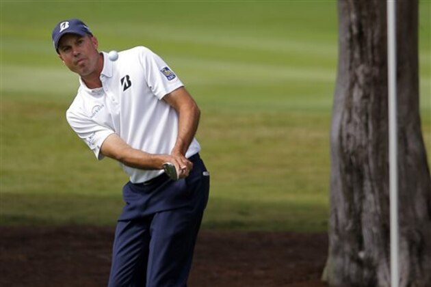 CORRECTS TO NINTH GREEN, NOT 18TH AS ORIGINALLY SENT - Matt Kuchar chips onto the ninth green during the second round of the McGladrey Classic golf tournament on Friday, Oct. 24, 2014, in St. Simons Island, Ga. (AP Photo/Stephen B. Morton)