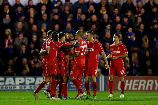KINGSTON UPON THAMES, ENGLAND - JANUARY 05:  Steven Gerrard (3rd L) of Liverpool is congratulated by teammates after scoring his team's second goal from a free kick during the FA Cup Third Round match between AFC Wimbledon and Liverpool at The Cherry Red Records Stadium on January 5, 2015 in Kingston upon Thames, England.  (Photo by Julian Finney/Getty Images)
