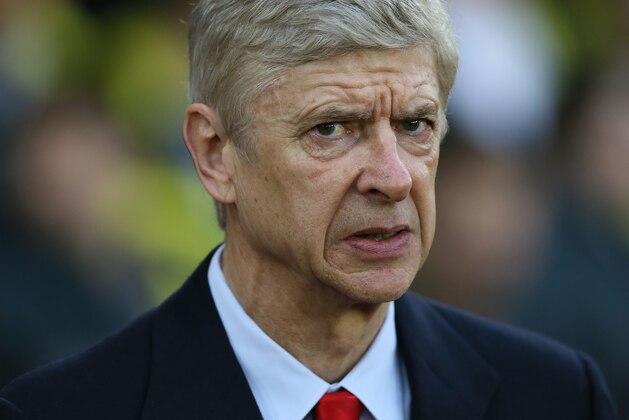 Arsenal manager Arsene Wenger looks across the pitch before the English Premier League soccer match between Southampton and Arsenal at St Mary's Stadium, Southampton, England, Thursday, Jan. 1, 2015. (AP Photo/Tim Ireland)