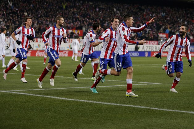 Atletico's Gimenez,  celebrates after scoring a goal during a King's Cup soccer match between Atletico de Madrid and Real Madrid at the Vicente Calderon stadium in Madrid, Spain, Wednesday, Jan. 7, 2015 . (AP Photo/Daniel Ochoa de Olza)