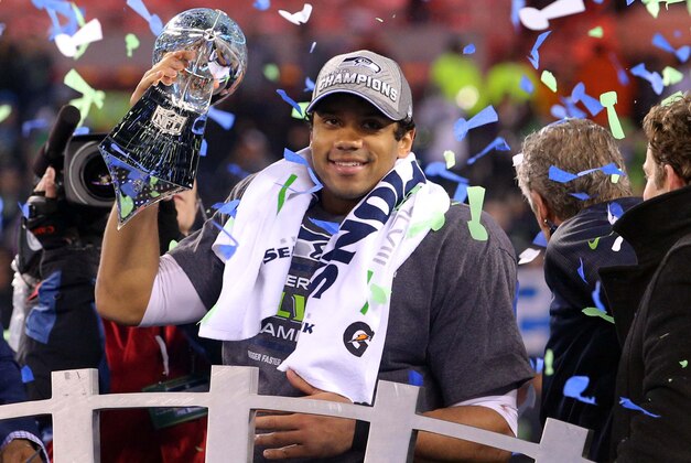 Feb 2, 2014; East Rutherford, NJ, USA; Seattle Seahawks quarterback Russell Wilson (3) celebrates with the Lombardi Trophy after beating the Denver Broncos 43-8 in Super Bowl XLVIII at MetLife Stadium.  Mandatory Credit: Brad Penner-USA TODAY Sports