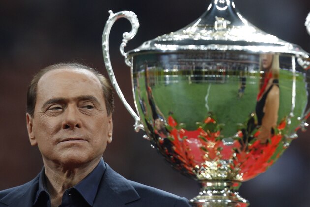Italian Premier Silvio Berlusconi attends the presentation of the 'Berluscon trophy'  after a  soccer match betweeen AC Milan and Juventus  at the San Siro stadium in Milan, Italy, Sunday, Aug.21, 2011. (AP Photo/Luca Bruno)