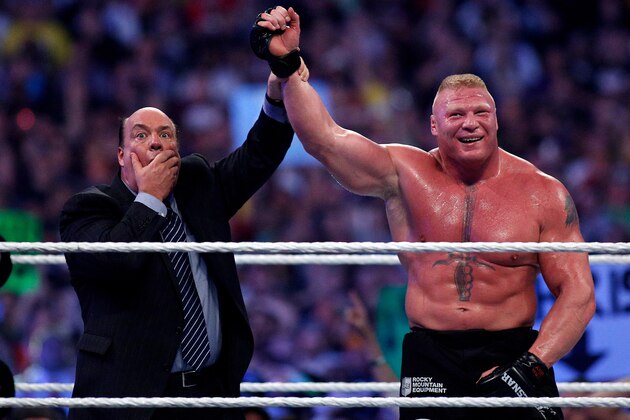 Paul Heyman, left, celebrates with Brock Lesnar after his win over the Undertaker  during Wrestlemania XXX at the Mercedes-Benz Super Dome in New Orleans on Sunday, April 6, 2014. (Jonathan Bachman/AP Images for WWE)