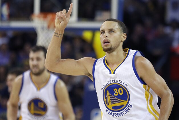 Golden State Warriors' Stephen Curry celebrates after scoring against the Brooklyn Nets during the second half of an NBA basketball game Thursday, Nov. 13, 2014, in Oakland, Calif. The Warriors won 107-99. (AP Photo/Ben Margot)