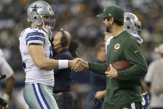 Dallas Cowboys long snapper L.P. LaDouceur (91) and Green Bay Packers quarterback Aaron Rodgers greet before an NFL football game, Sunday, Dec. 15, 2013, in Arlington, Texas. (AP Photo/Tim Sharp)