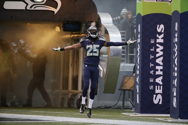 Seattle Seahawks cornerback Richard Sherman runs out of the tunnel before an NFL football game against the St. Louis Rams, Sunday, Dec. 28, 2014, in Seattle. (AP Photo/Elaine Thompson)