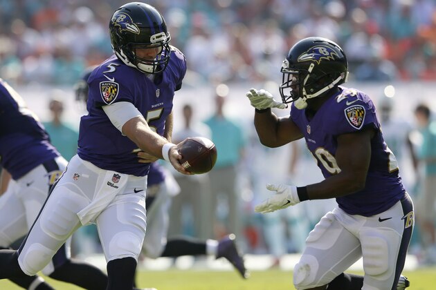 MIAMI GARDENS, FL - DECEMBER 07:  Quarterback Joe Flacco #5 of the Baltimore Ravens hands off to running back Justin Forsett #29 of the Baltimore Ravens  against the Miami Dolphins in the second quarter during a game at Sun Life Stadium on December 7, 2014 in Miami Gardens, Florida.  (Photo by Mike Ehrmann/Getty Images)