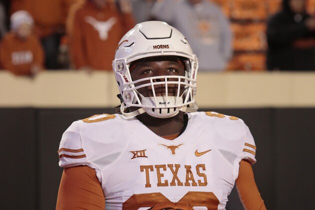 STILLWATER, OK - NOVEMBER 15:   Defensive tackle Malcom Brown #90 of the Texas Longhorns looks at the video board before the game against the Oklahoma State Cowboys November 15, 2014 at Boone Pickens Stadium in Stillwater, Oklahoma. The Longhorns defeated the Cowboys 28-7.  (Photo by Brett Deering/Getty Images)