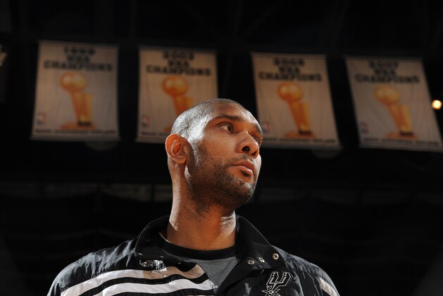 SAN ANTONIO, TX - MAY 17: Tim Duncan #21 of the San Antonio Spurs stands under the team's championship banners before facing the Los Angeles Clippers in Game Two of the Western Conference Semifinals during the 2012 NBA Playoffs on May 17, 2012 at the AT&T Center in San Antonio, Texas. NOTE TO USER: User expressly acknowledges and agrees that, by downloading and/or using this photograph, user is consenting to the terms and conditions of the Getty Images License Agreement. Mandatory Copyright Notice: Copyright 2012 NBAE (Photo by Garrett W. Ellwood/NBAE via Getty Images)