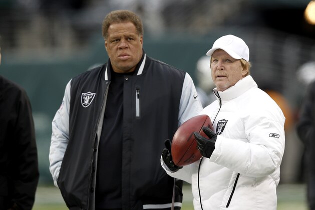 Oakland Raiders owner Mark Davis, right, stands with general manger Reggie McKenzie before an NFL football game against the New York Jets, Sunday, Dec. 8, 2013, in East Rutherford, N.J. (AP Photo/Kathy Willens)