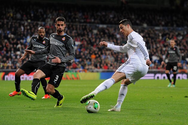 MADRID, SPAIN - JANUARY 28:  Cristiano Ronaldo (R) of Real Madrid CF controls the ball beside Raul Rodriguez of RCD Espanyol during the Copa Del Rey Quarter Final, 2nd leg match between Real Madrid CF and RCD Espanyol at Estadio Santiago Bernabeu on January 28, 2014 in Madrid, Spain.  (Photo by Denis Doyle/Getty Images)