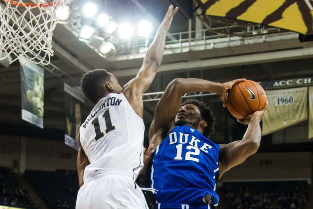 Jan 7, 2015; Winston-Salem, NC, USA; Duke Blue Devils forward Justise Winslow (12) goes up for a shot against Wake Forest Demon Deacons forward Greg McClinton (11) during the second half at Lawrence Joel Veterans Memorial Coliseum. Duke defeated Wake Forest 73-65. Mandatory Credit: Jeremy Brevard-USA TODAY Sports