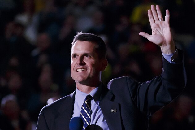 Dec 30, 2014; Ann Arbor, MI, USA; Michigan Wolverines head football coach Jim Harbaugh address the crowd during halftime of the basketball game against the Illinois Fighting Illini at Crisler Center. Mandatory Credit: Rick Osentoski-USA TODAY Sports