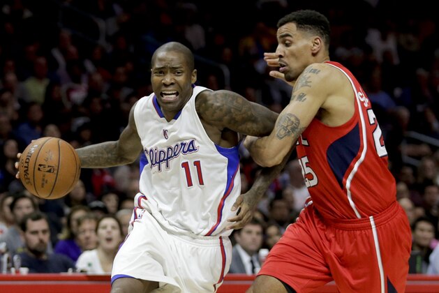 Los Angeles Clippers guard Jamal Crawford, left, is fouled by Atlanta Hawks guard Thabo Sefolosha during the second half of an NBA basketball game in Los Angeles, Monday, Jan. 5, 2015. The Hawks won 107-98. (AP Photo/Chris Carlson)