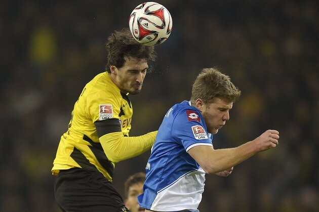 Dortmund's Mats Hummels, left, and Hoffenheim's Sven Schipplock challenge for the ball during the German Bundesliga soccer match between Borussia Dortmund and TSG Hoffenheim in Dortmund,  Germany, Friday, Dec. 5, 2014. (AP Photo/Martin Meissner)