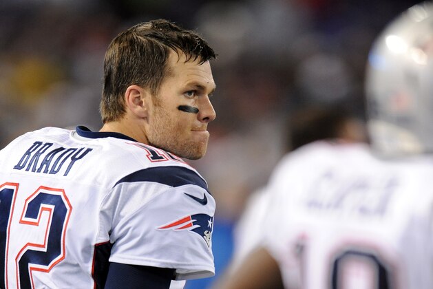 New England Patriots quarterback Tom Brady stands on the sideline in the first half of an NFL football game against the Baltimore Ravens, Sunday, Dec. 22, 2013, in Baltimore. (AP Photo/Gail Burton)