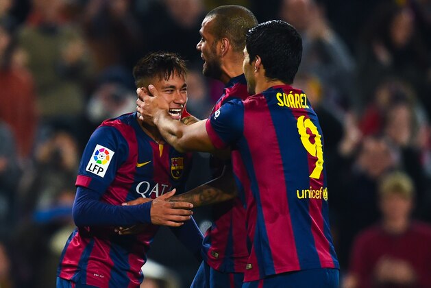 BARCELONA, SPAIN - JANUARY 08:  Neymar of FC Barcelona celebrates with his teammates Dani Alves (C) and Luis Suarez of FC Barcelona after scoring his team's fifth goal during the Copa del Rey Round of 16 First Leg match between FC Barcelona and Elche CF at Camp Nou on January 8, 2015 in Barcelona, Spain.  (Photo by David Ramos/Getty Images)