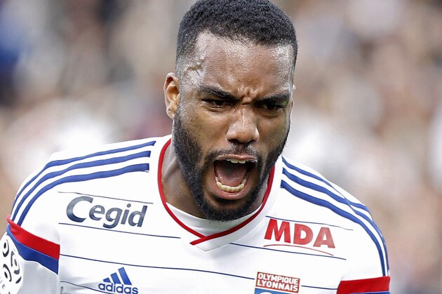 Lyon's Alexandre Lacazette celebrates after he scored his first goal against Lille during their French League One soccer match in Lyon, central France, Sunday, Oct. 5, 2014. (AP Photo/Laurent Cipriani)