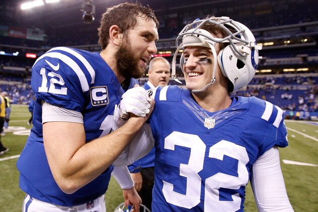 INDIANAPOLIS, IN - JANUARY 04: Andrew Luck #12 and Colt Anderson #32 of the Indianapolis Colts leave the field after their win over the Cincinnati Bengals during their AFC Wild Card game at Lucas Oil Stadium on January 4, 2015 in Indianapolis, Indiana.  (Photo by Joe Robbins/Getty Images)