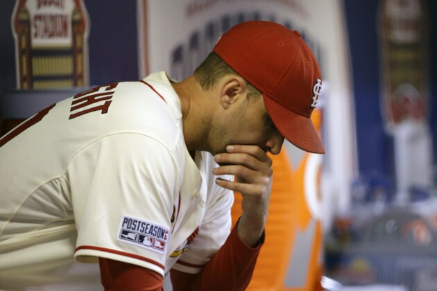 St. Louis Cardinals starting pitcher Adam Wainwright sits in the dugout after being taken out of the game during the fifth inning in Game 1 of the National League baseball championship series against the San Francisco Giants Saturday, Oct. 11, 2014, in St. Louis. (AP Photo/David J. Phillip)