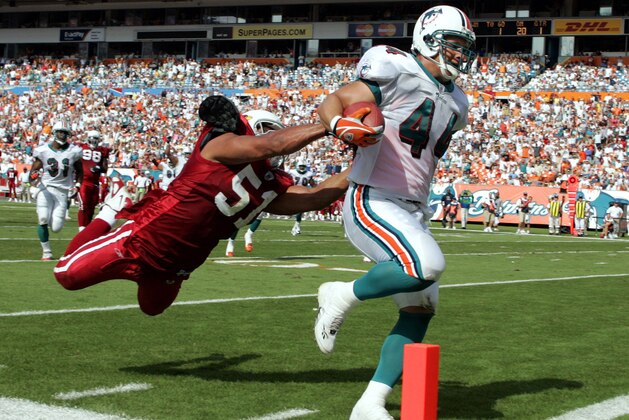 MIAMI - NOVEMBER 7:  Fullback Rob Konrad #44 of the Miami Dolphins heads into the end zone for a touchdown against Linebacker James Darling #51 of the Arizona Cardinals in the first quarter at Pro Player Stadium on November 7, 2004 in Miami, Florida. (Photo by Eliot J. Schechter/Getty Images)