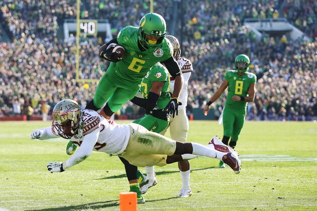 Oregon wide receiver Charles Nelson (6) scores over Florida State defensive back Nate Andrews during the first half in the Rose Bowl NCAA college football playoff semifinal, Thursday, Jan. 1, 2015, in Pasadena, Calif. (AP Photo/Doug Benc)