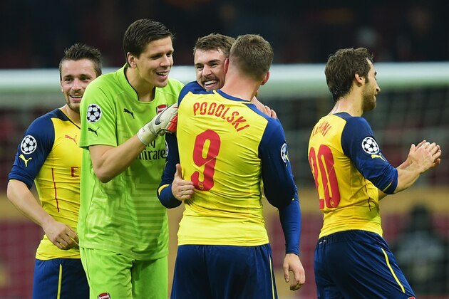 ISTANBUL, TURKEY - DECEMBER 09:  Aaron Ramsey of Arsenal (3L) celebrates with team mates Wojciech Szczesny (2L) and Lukas Podolski (9) as he scores their third goal during the UEFA Champions League Group D match between Galatasaray AS and Arsenal FC at Ali Sami Yen Arena on December 9, 2014 in Istanbul, Turkey.  (Photo by Jamie McDonald/Getty Images)