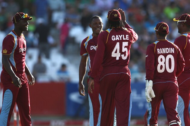 CAPE TOWN, SOUTH AFRICA - JANUARY 09: Sheldon Cottrell of the West Indies is congratulated by Chris Gayle of the West Indies for getting Reeza Hendricks of South Africa wicket during the 1st KFC T20 International match between South Africa and West Indies at Sahara Park Newlands on January 09, 2015 in Cape Town, South Africa. (Photo by Shaun Roy/Gallo Images/Getty Images)