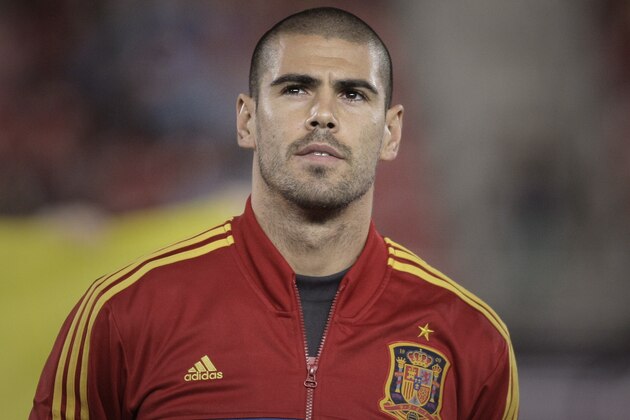 Spain's Victor Valdes listens to the national anthems before a 2014 World Cup Group I qualifying soccer match between Spain and Belarus at the Iberostar Estadi in Palma de Mallorca, Spain, Friday Oct. 11, 2013. (AP Photo/Manu Mielniezuk)