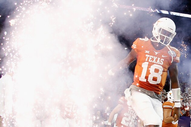 HOUSTON, TX - DECEMBER 29:  Tyrone Swoopes #18 of the Texas Longhorns runs with his team onto the field at the start of their game against the Arkansas Razorbacks at the AdvoCare V100 Texas Bowl at NRG Stadium on December 29, 2014 in Houston, Texas.  (Photo by Scott Halleran/Getty Images)